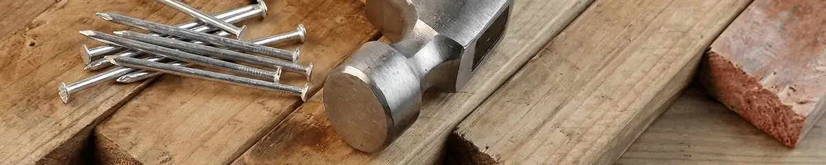 Hammer and nails on hardwood flooring boards in Tuscaloosa, AL