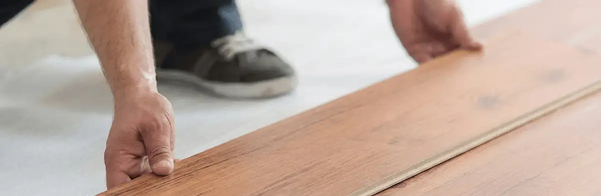 A professional installing laminate flooring in Tuscaloosa, AL