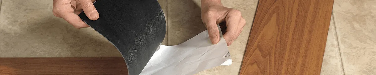 A professional installing vinyl flooring in Tuscaloosa, AL