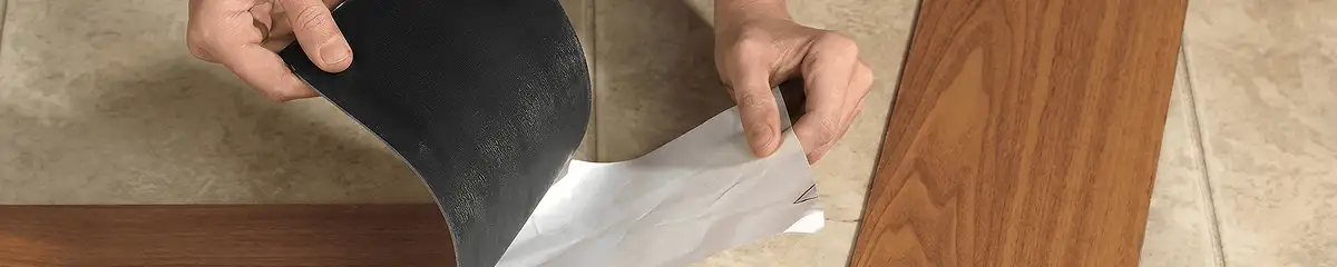 A professional installing vinyl flooring in Tuscaloosa, AL