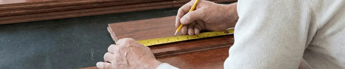 A professional installing wood flooring in Tuscaloosa, AL